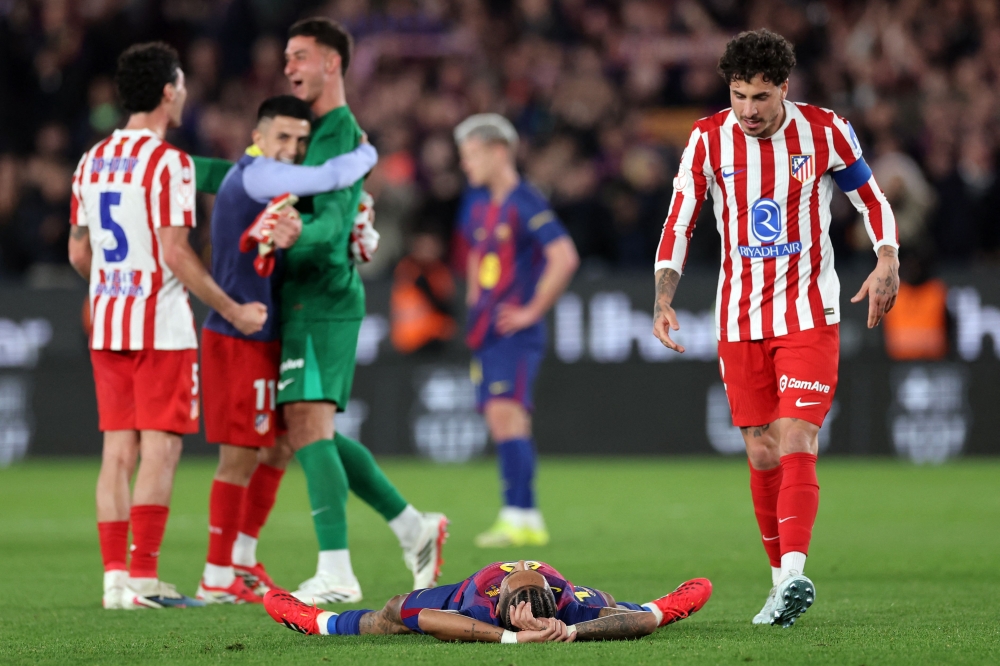 Barcelona's Brazilian forward #11 Raphinha lies on the field at the end of the Copa del Rey (King's Cup) semi final second leg football match between FC Barcelona and Club Atletico de Madrid at Camp Nou Stadium in Barcelona on March 3, 2026. — AFP pic 