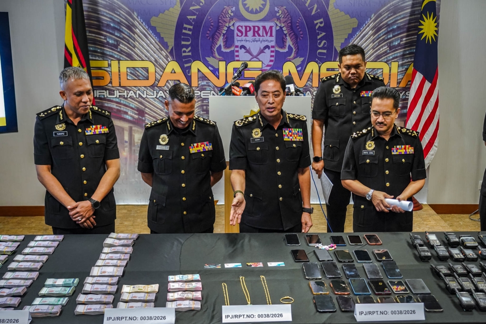 MACC Chief Commissioner Tan Sri Azam Baki gestures towards items seized under ‘Ops Middleman’ during a press conference at the MACC headquarters in Putrajaya, March 4, 2026. — Picture by Firdaus Latif