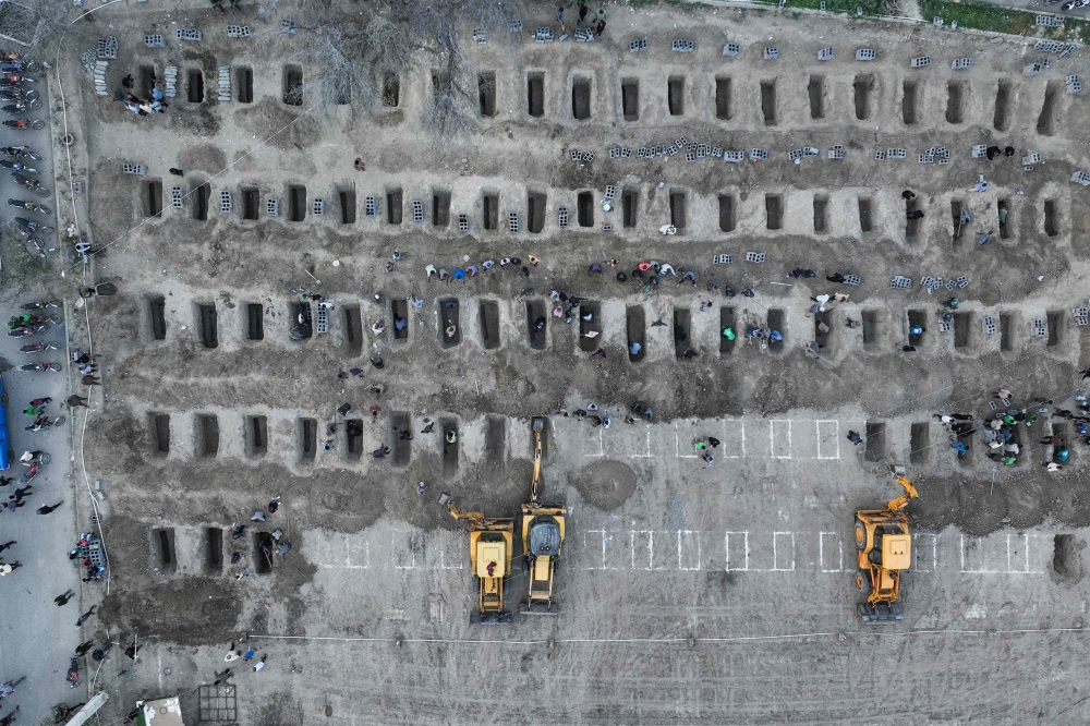 In this aerial handout picture released by the Iranian Press Center, mourners dig graves during the funeral for children killed in a reported strike on a primary school in Iran’s Hormozgan province in Minab on March 3, 2026. — Iranian Press Center handout pic via AFP