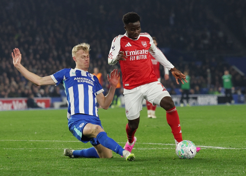 Brighton & Hove Albion’s Jan Paul van Hecke in action with Arsenal’s Bukayo Saka at the The American Express Community Stadium, Brighton, March 4, 2026. — Action Images pic via Reuters