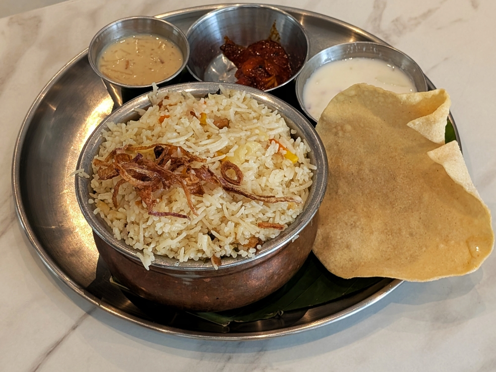 Lamb Kerala Biryani comes with pickle, ‘raita’ and a ‘pappadam’. — Picture by Ethan Lau