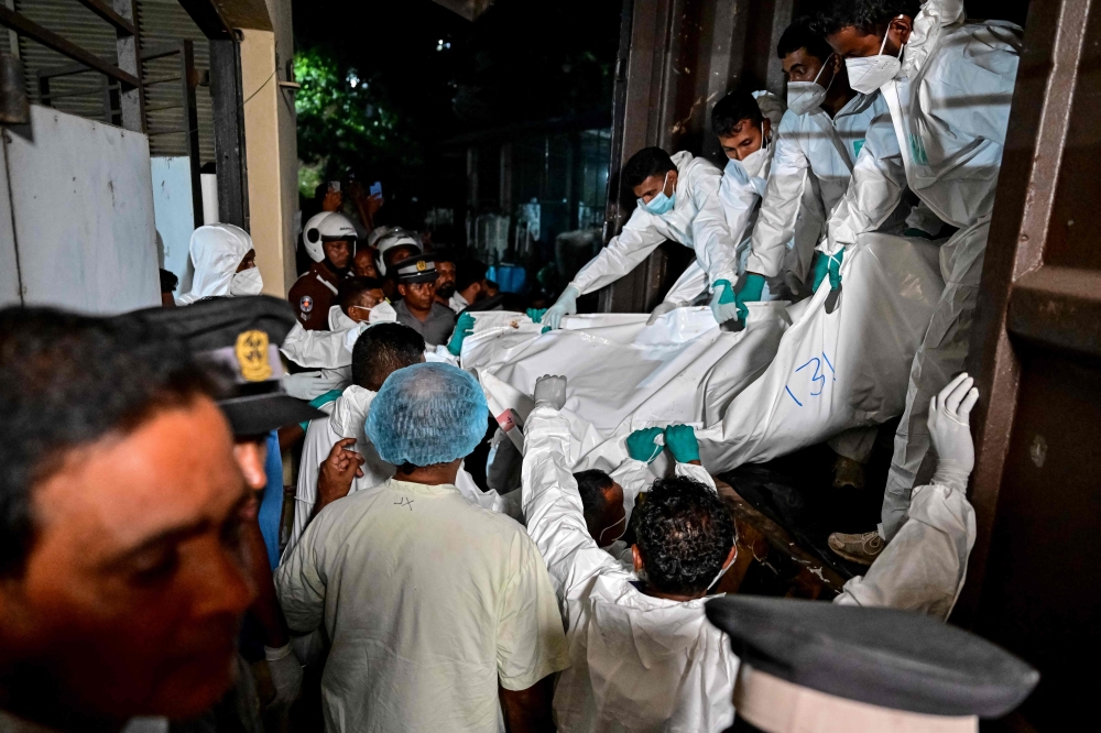 Healthcare workers carry the bodies of Iranian sailors who died in a US torpedo attack on their frigate IRIS Dena off Sri Lanka’s southern coast, at the mortuary of the Karapitiya hospital in Galle on March 4, 2026. A second Iranian warship was heading towards Sri Lanka’s territorial waters Thursday, a day after a US submarine destroyed an Iranian frigate, killing at least 87 sailors, a minister told parliament. — AFP pic 