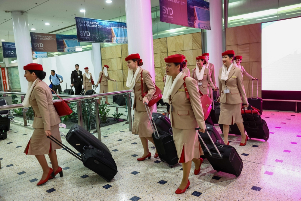 Emirates Airlines crew members arrive at Sydney Kingsford Smith International Airport after a flight from Dubai on March 4, 2026. — AFP pic