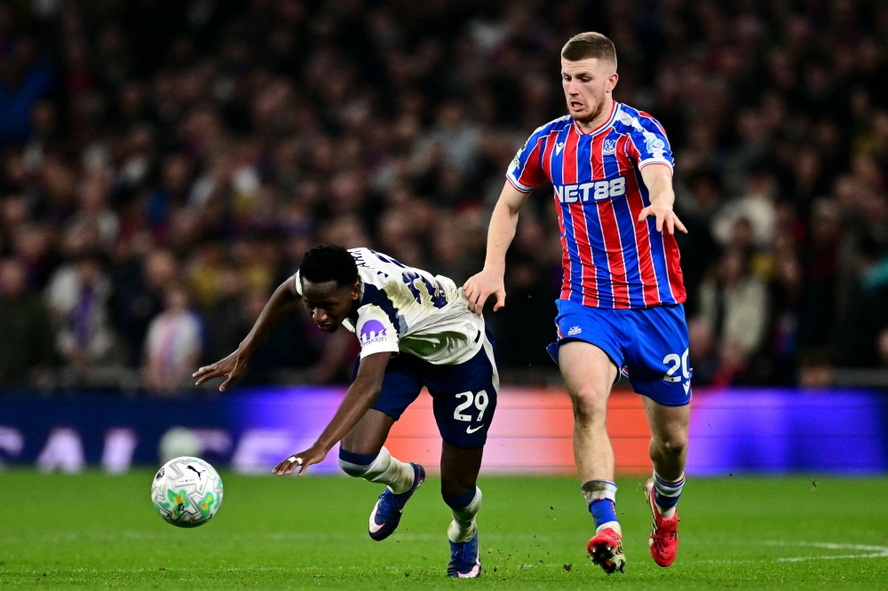 Tottenham Hotspur forward Pape Matar Sarr is tackled by Crystal Palace midfielder Adam Wharton during the Premier League match at the Tottenham Hotspur Stadium in London on March 5, 2026. — AFP pic