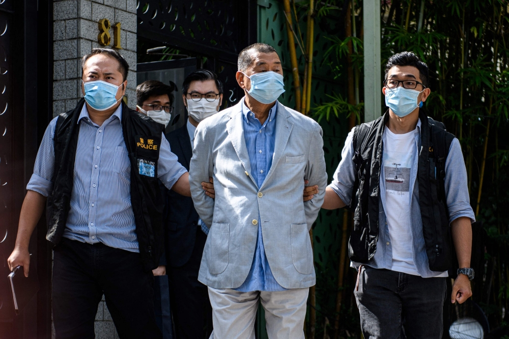 Police lead former Hong Kong media mogul Jimmy Lai away from his home after his arrest under the national security law in 2020; Lai was found guilty on December 15, 2025, of collusion and sedition. — AFP pic