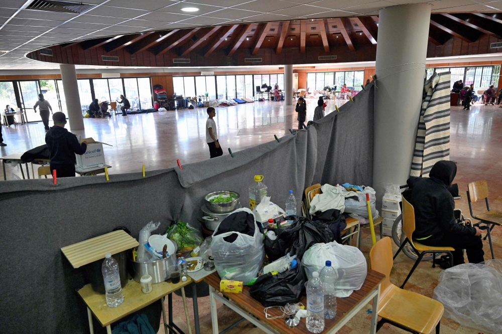 People sit inside a school transformed into a shelter for displaced people in the town of Dekwaneh north of Beirut, Lebanon on March 5, 2026 after US-Israeli bombardment across the Middle East region. — AFP pic