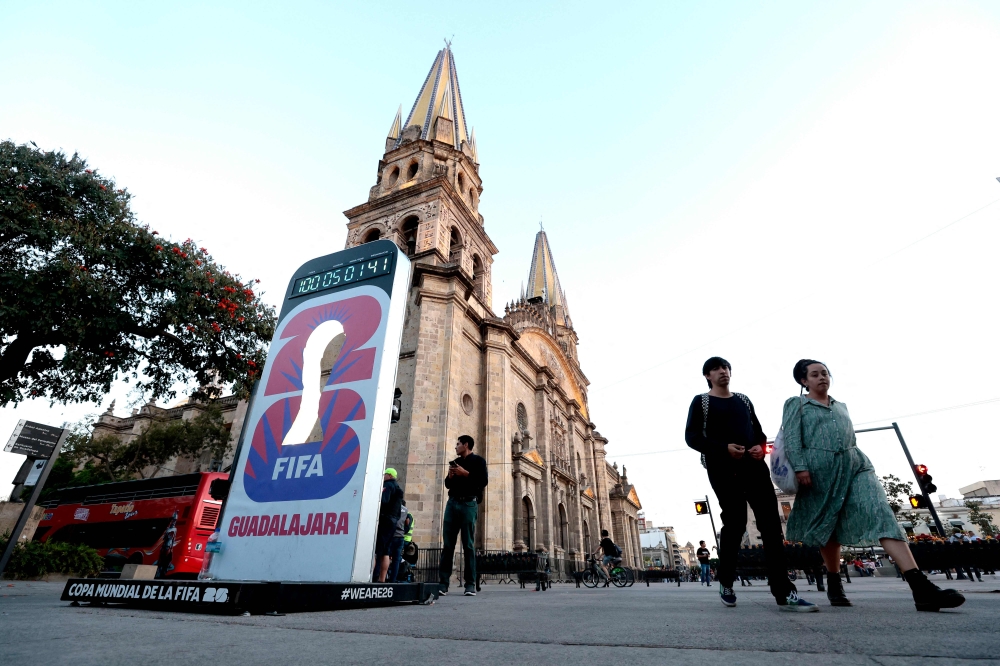 People walk past a countdown clock marking 100 days until the 2026 Fifa World Cup next to the Cathedral in Guadalajara, Jalisco state, Mexico, on March 2, 2026. — AFP pic 