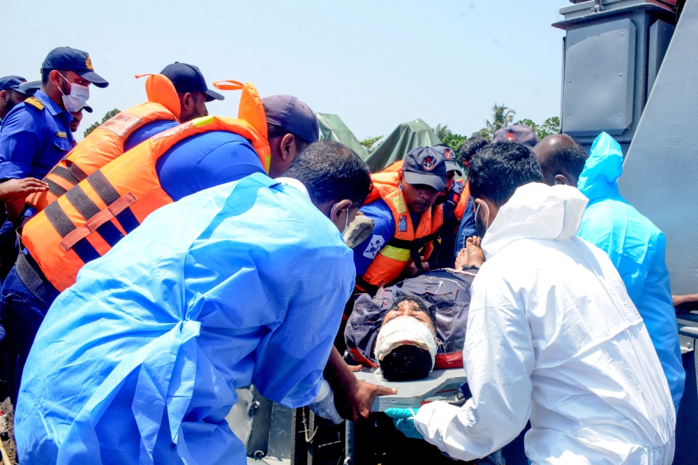 Medical personnel and Sri Lanka Navy sailors provide emergency treatment to an injured Iranian crew member rescued after responding to a distress call from the Iranian military ship, IRIS Dena, while at sea within Sri Lanka’s maritime search and rescue region, in Indian Ocean, Sri Lanka, March 4, 2026. — Sri Lanka Navy handout pic via Reuters 