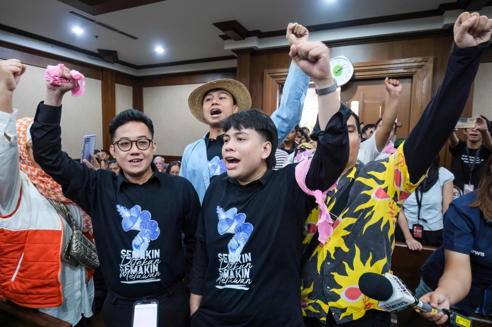(From left) Delpedro Marhaen Rismansyah, executive director of Lokataru, Khariq Anhar, Muzaffar Salim, and Syahdan Husein, all defendants in an alleged incitement case related to demonstrations that ended in riots between August 25–30, 2025, gesture and shout slogans before hearing the judges’ verdict at the Central Jakarta District Court in Jakarta March 6, 2026. — AFP pic 