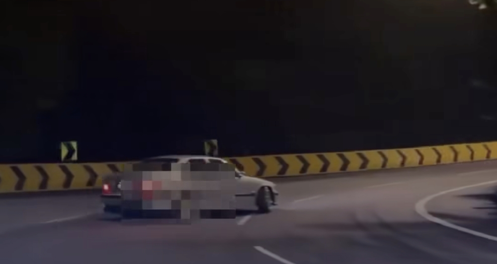A BMW 325i seen performing a drift along a winding road leading up to Genting Highlands in a 14-second video that later went viral on TikTok, prompting police to arrest the 29-year-old driver and seize the vehicle for investigation. — Screengrab from Facebook video
