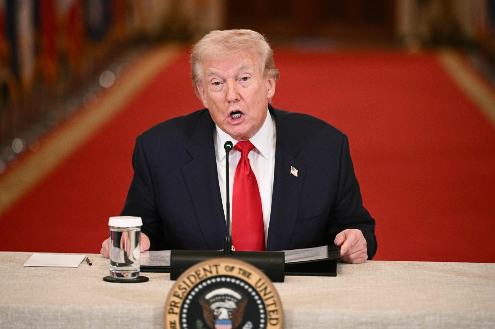 US President Donald Trump said yesterday that only Tehran’s unconditional surrender would bring an end to the escalating Middle East war as crude oil prices surged on fears about global supply disruption. — AFP pic 