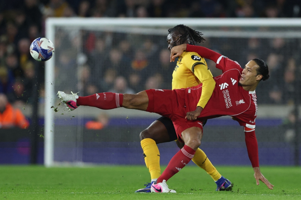 Wolverhampton Wanderers' Nigerian striker #14 Tolu Arokodare (L) vies with Liverpool's Dutch defender #04 Virgil van Dijk (right) during the English FA Cup fifth round football match between Wolverhampton Wanderers and Liverpool at the Molineux stadium in Wolverhampton, central England on March 6, 2026. — AFP pic 