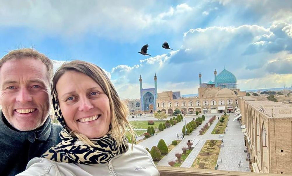 British couple Craig (left) and Lindsay Foreman, both 52, pose for selfies at Naqsh-e Jahan Square, or Shah Square, with the Shah Mosque in the background, in Isfahan, Iran, at an undated time before they were detained on suspicion of espionage in 2025. — Family handout picture via AFP