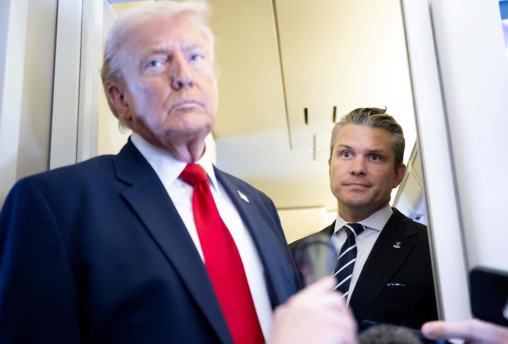 Gemini saidUS President Donald Trump speaks with the media as Defense Secretary Pete Hegseth looks on aboard Air Force One during a flight from Dover, Delaware, to Miami, Florida on March 7, 2026. — AFP pic