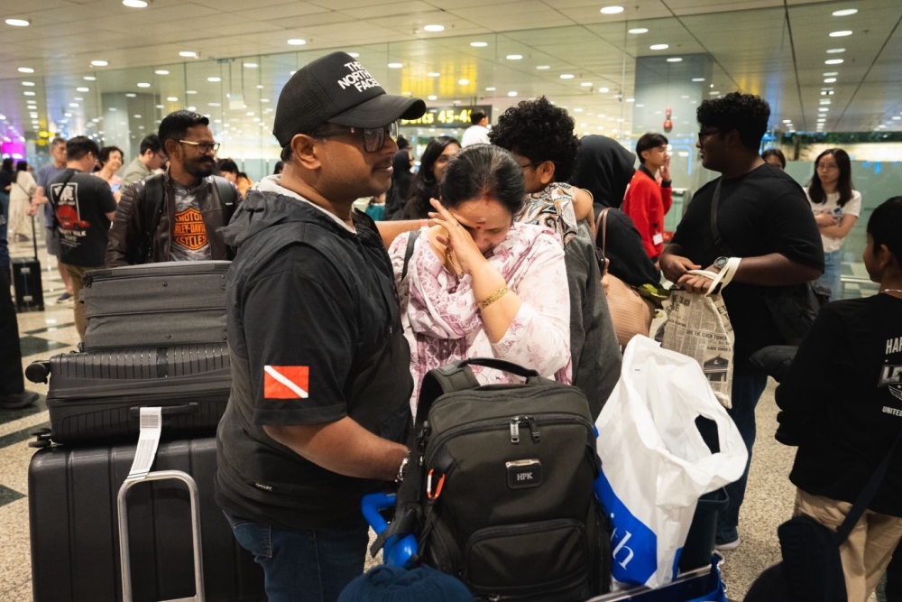 Passengers arrive at Singapore’s Changi Airport after a repatriation flight from Muscat, Oman. Stranded Malaysians were among those on board. — Picture via Facebook/SingaporeMFA