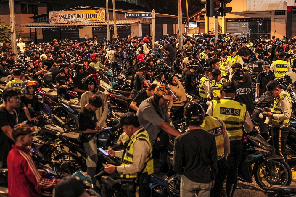Traffic police officers inspect motorcyclists during an integrated traffic enforcement operation around Jalan Semarak in Kuala Lumpur March 8, 2026. — Bernama pic