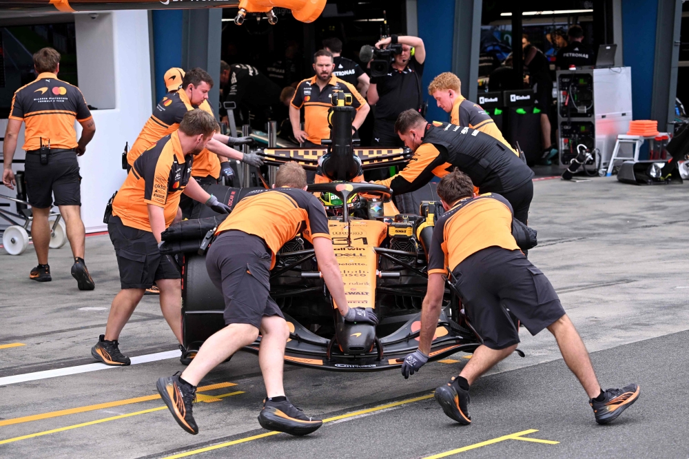 Mechanics work on the car of McLaren's Australian driver Oscar Piastri in the pits during the qualifying session for the Australian Grand Prix at the Albert Park Circuit in Melbourne on March 7, 2026. — AFP pic