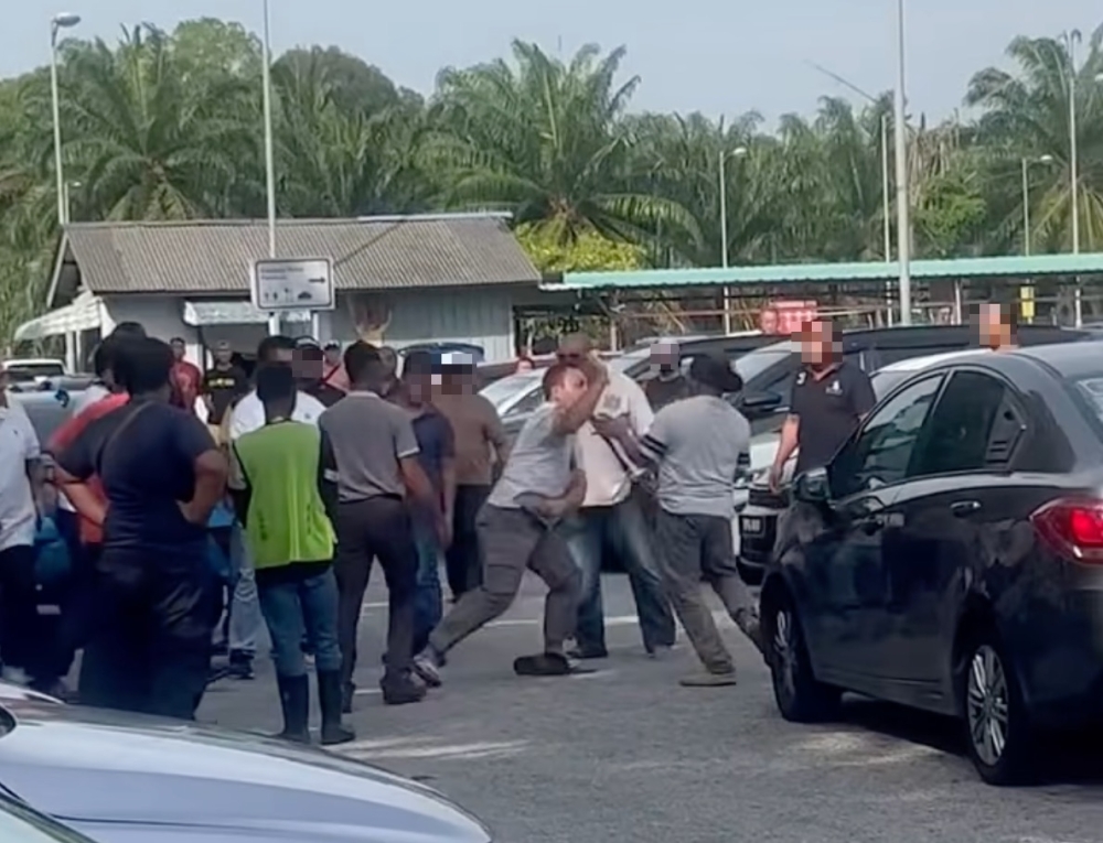 A screengrab from a video circulating on social media shows two e-hailing drivers exchanging blows during a dispute over a parking space at the e-hailing long-term car park at Kuala Lumpur International Airport on March 4. Police said both men later agreed to settle the matter amicably after statements were recorded.