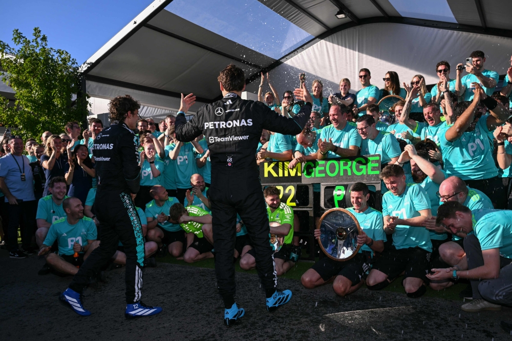 First-placed George Russell and second-placed Kimi Antonelli celebrate with the Mercedes team after the Australian Grand Prix at the Albert Park Circuit in Melbourne on March 8, 2026. — AFP pic