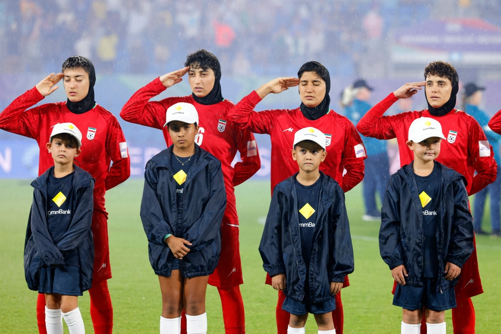 Iran's players salute during the national anthem before the AFC Women's Asian Cup Australia 2026 football match against Philippines in Gold Coast. — AFP pic