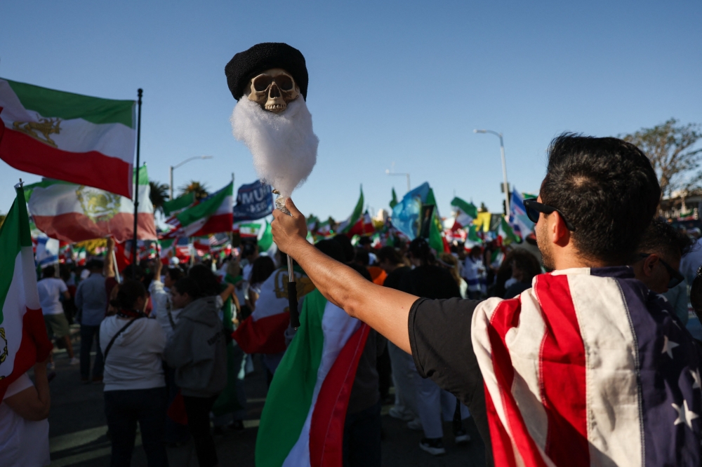 A skull with a beard is raised into the air as while Iranian community members gather in support of regime change in Iran outside of the Westwood Federal Building in Los Angeles. — AFP pic