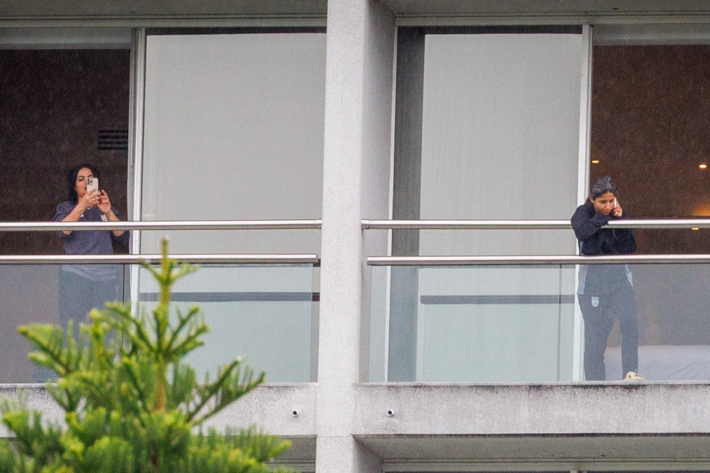 Members of the Iranian women's football team are seen on their respective room balconies at the Royal Pines Resort on the Gold Coast. — AFP pic