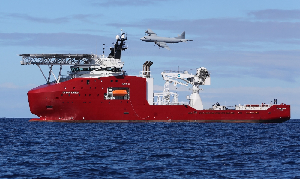 A Royal Australian Air Force AP-3C Orion flies past Ocean Shield during the search for missing Malaysia Airlines flight MH370 on April 9, 2014. — AFP pic/Australian Defence handout