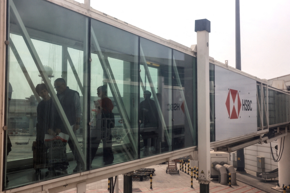 Passengers walk through a jet bridge at Dubai International Airport, amid the US-Israeli conflict with Iran, in Dubai March 8, 2026. The Malaysian government is in the final phase of preparations to carry out the evacuation of Malaysians from several countries affected by the conflict in the Middle East following increasingly deteriorating security developments in the region. — Reuters pic 