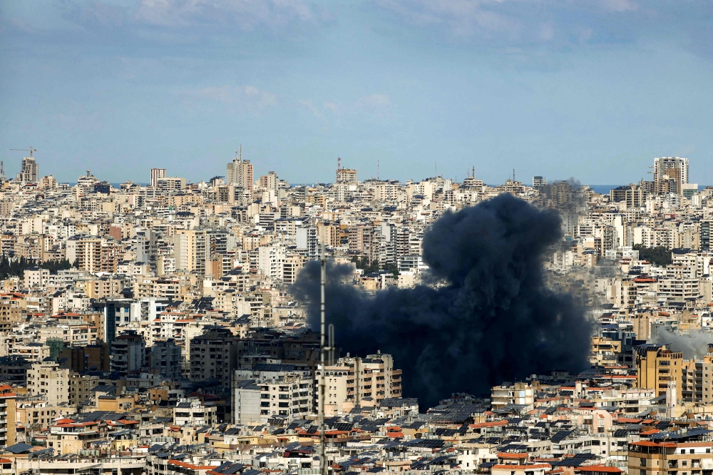 A smoke cloud erupts from the site of an Israeli airstrike on Beirut southern suburbs on March 9. — AFP pic