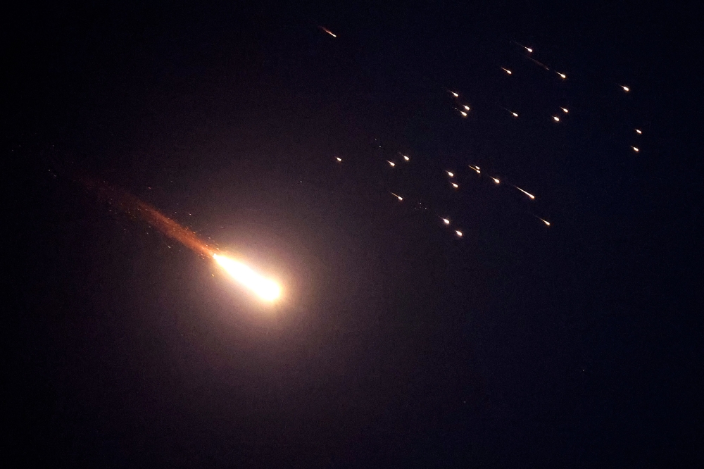 Rocket trails are seen in the sky above Netanya on March 7, 2026. The Israeli military said it detected multiple missile barrages from Iran on March 7, as well as launches from Lebanon, triggering air raid sirens across the country. — AFP pic