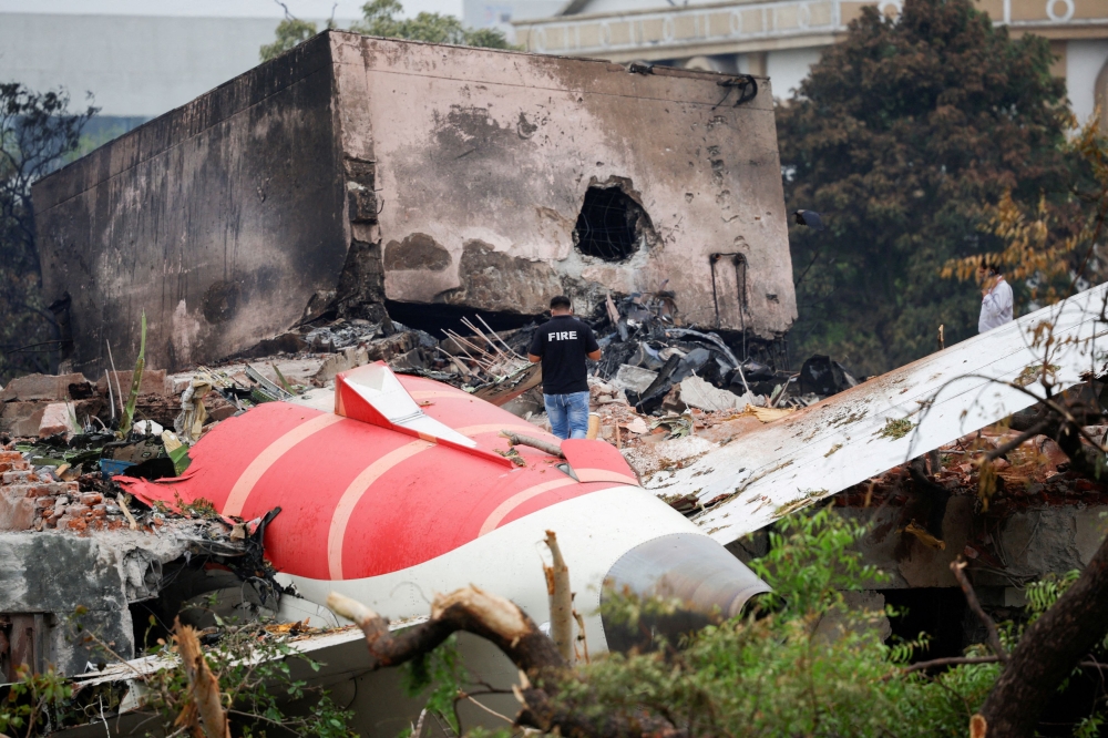 A fire officer stands next to the crashed Air India Boeing 787-8 Dreamliner aircraft, in Ahmedabad June 13, 2025. — Reuters pic