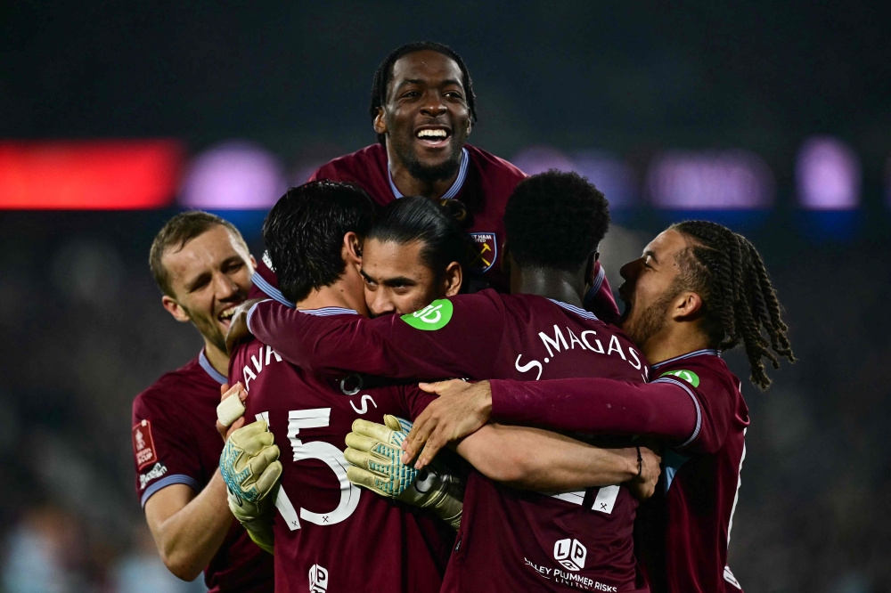 West Ham's players celebrate after winning the English FA Cup fifth round football match against Brentford FC. — AFP pic