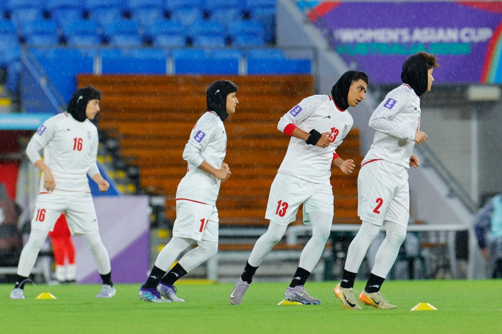 This photo, taken on March 8, 2026, shows Iranian players warming up before the AFC Women's Asian Cup Australia 2026 football match between Iran and the Philippines on the Gold Coast. — AFP pic