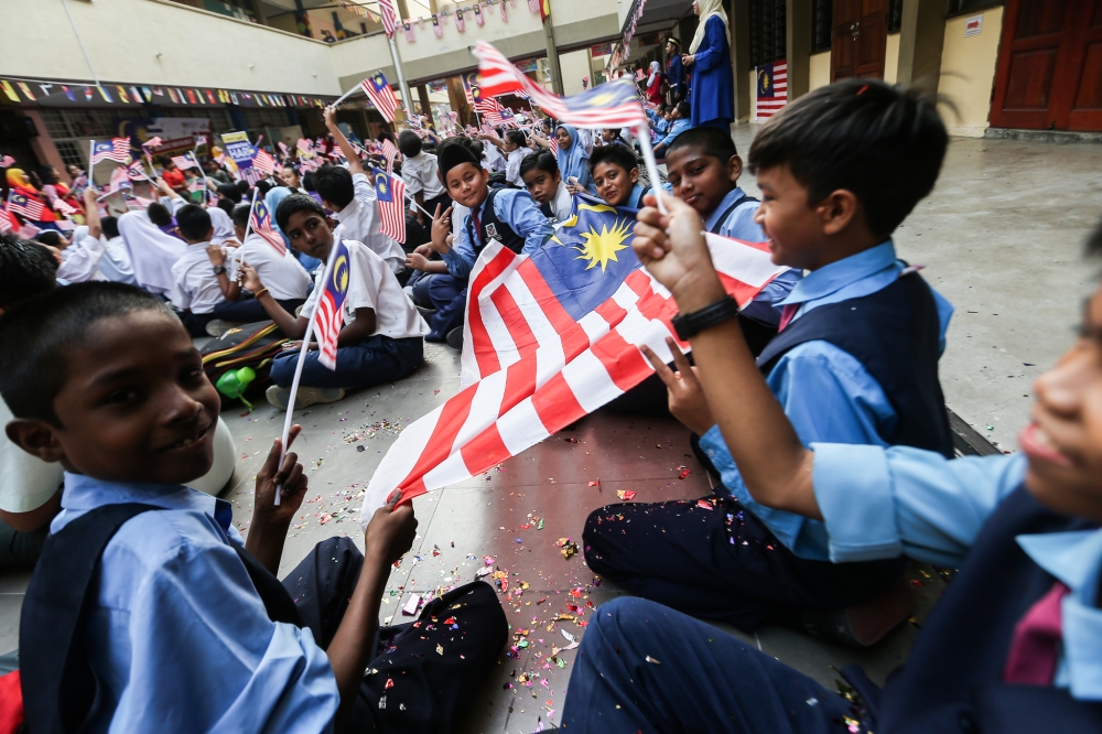 File picture of primary school pupils with the Jalur Gemilang during   the launch of the Merdeka Month Celebration 2018 at SK Perdana Jaya SS19 in Subang Jaya, August 17, 2018. — Picture by Hari Anggara