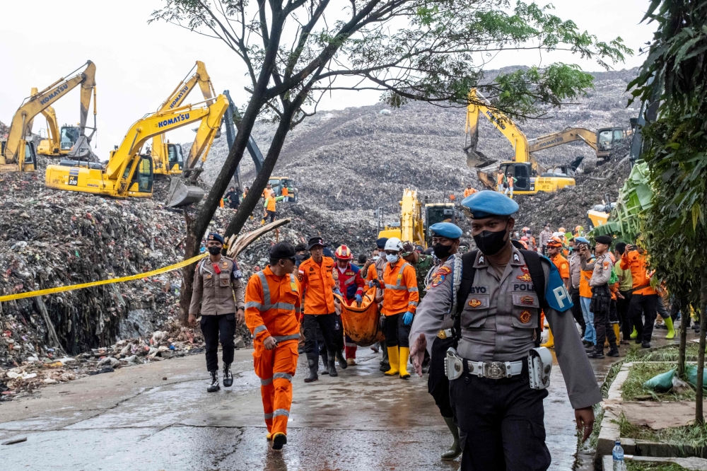 Rescuers evacuate a victim following a landslide at Bantargebang landfill in Bekasi, West Java, on March 9, 2026. — AFP pic