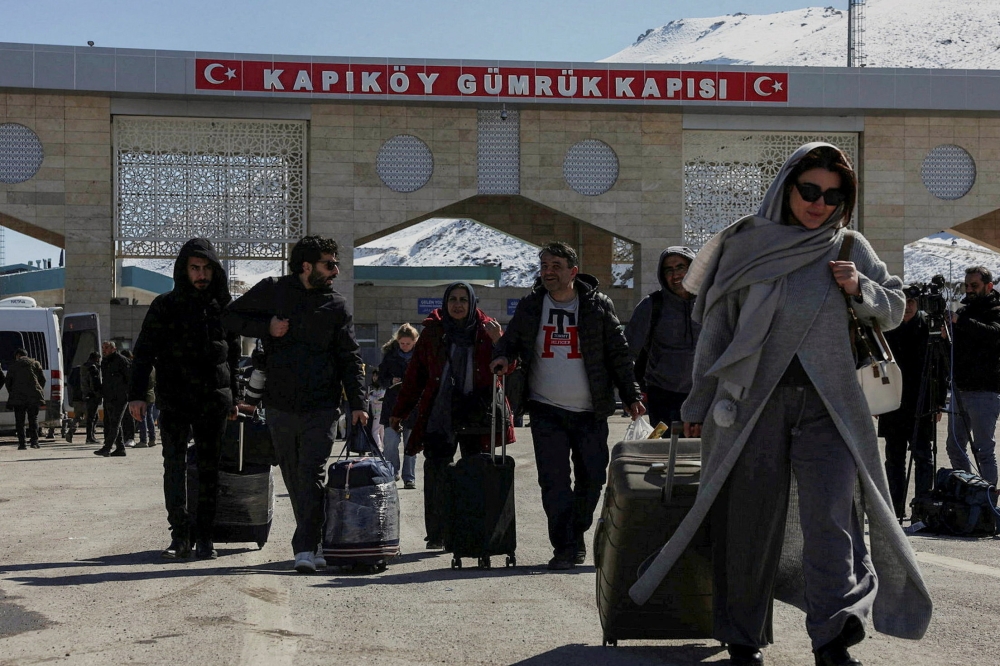 Iranians make their way after crossing into Turkiye at the Kapikoy Border Gate in the eastern Van province, Turkiye, March 3, 2026. — Reuters pic