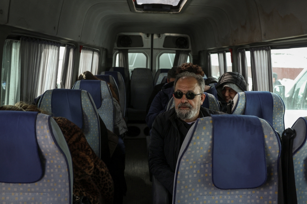 Ebrahim Eidi, 61, who arrived in Turkiye from Iran, is seen sitting in a van as he prepares to depart in Van province, Turkiye, March 6, 2026. Eidi said many Iranians still hoped for change but feared taking action themselves. ‘People are afraid to go to the streets.’ — Reuters pic