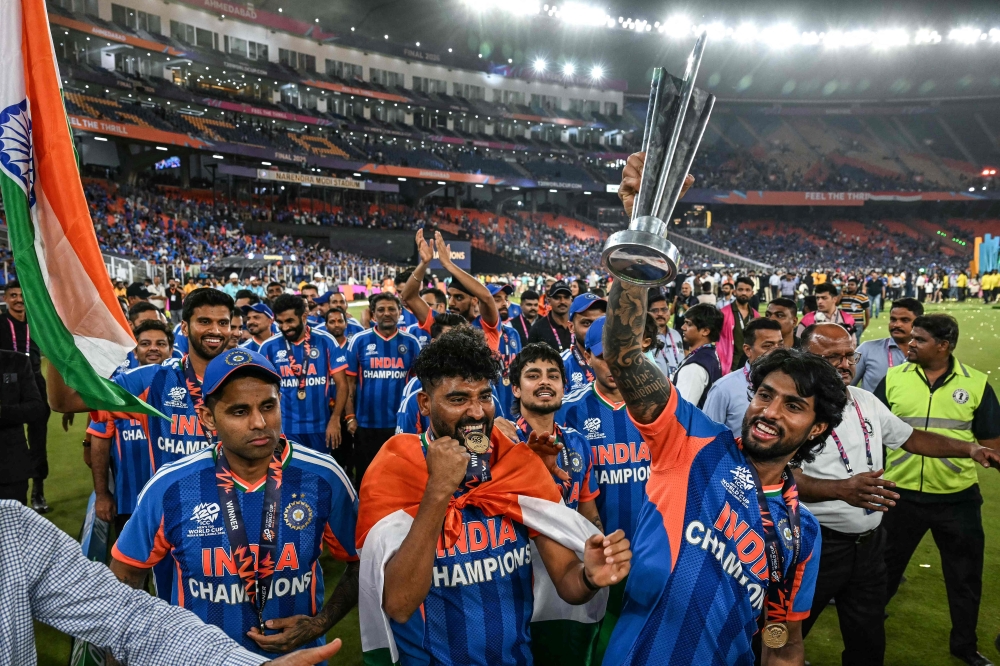 (L-R) India's captain Suryakumar Yadav, Mohammed Siraj, Ishan Kishan and Tilak Varma celebrate with the trophy during a victory lap after winning the 2026 ICC Men's T20 Cricket World Cup final match against New Zealand. — AFP pic