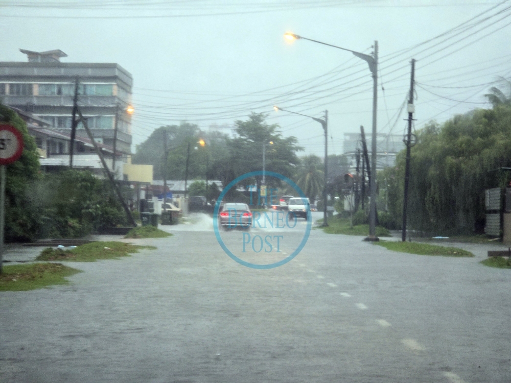 The inundated road near Laman Bong Chin. — The Borneo Post pic