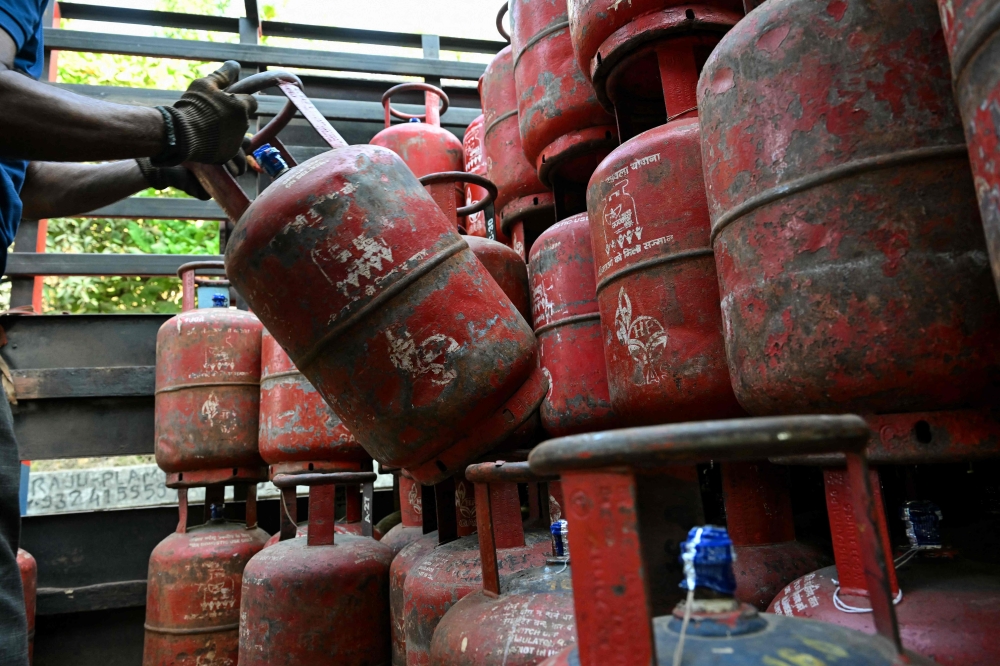 A delivery staff member unloads liquefied petroleum gas (LPG) cylinders from a truck at a distribution point in Mumbai on March 10, 2026. — AFP pic