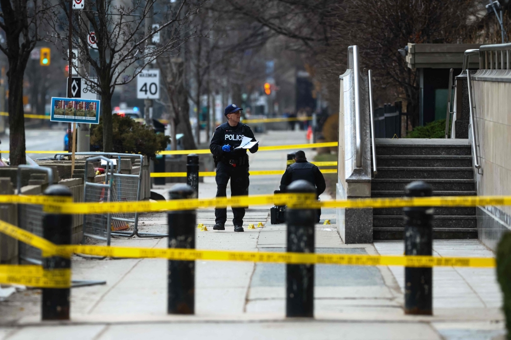 Toronto Police officers work around the scene of a shooting at the US Consulate in Toronto, Canada, on March 10. — AFP pic