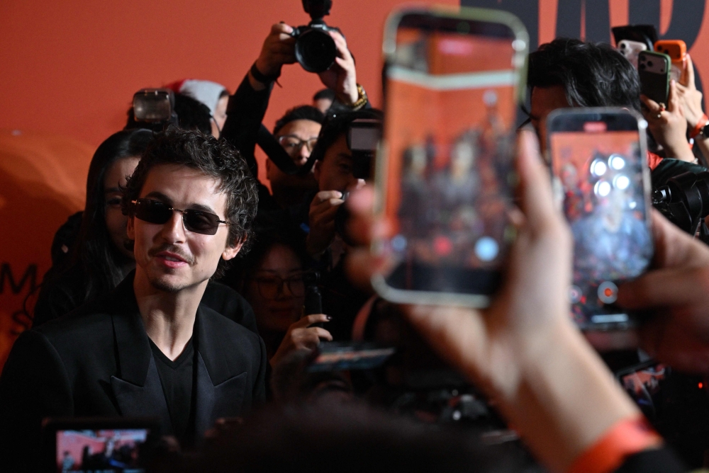 Timothée Chalamet speaks to journalists on the red carpet during screening of his film ‘Marty Supreme’ in Beijing March 10, 2026. — AFP pic