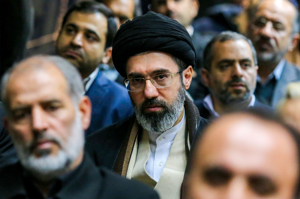 In this picture obtained from Iran’s ISNA news agency, Mojtaba Khamenei (centre), son of Iran’s supreme leader Ayatollah Ali Khamenei, looks on during a gathering in Tehran July 18, 2016. — AFP pic