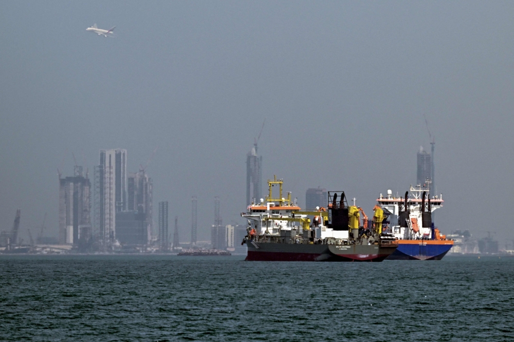 Commercial vessels are pictured offshore in Dubai on March 11, 2026. New attacks hit three commercial ships in the Gulf on March 11, with one of the vessels in flames as Iran pressed its campaign against its oil-exporting neighbours, threatening shipping in the Strait of Hormuz and plunging the global energy economy into crisis. 