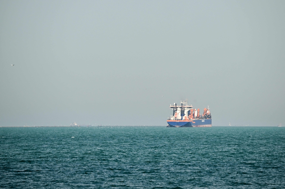 One stranded Philippine sailor who has been posting online videos of his experiences under the name Choi described a vote in which the crew was asked if they wanted to risk passage through the strait, where traffic has slowed to a trickle. — AFP pic