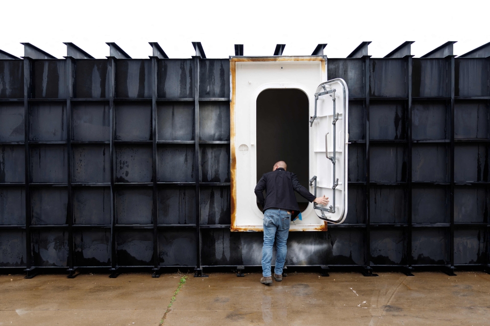 Shop manager Davis Yarber opens up a survival shelter door at the Atlas Survival Shelters factory in Sulphur Springs, Texas on March 7, 2026. — AFP pic