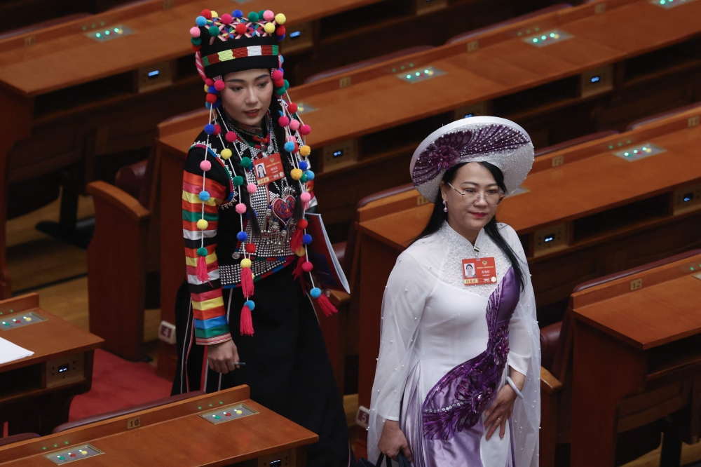 Delegates leave at the end of the closing session of the Chinese People's Political Consultative Conference (CPPCC) at the Great Hall of the People in Beijing on March 11, 2026. — AFP pic