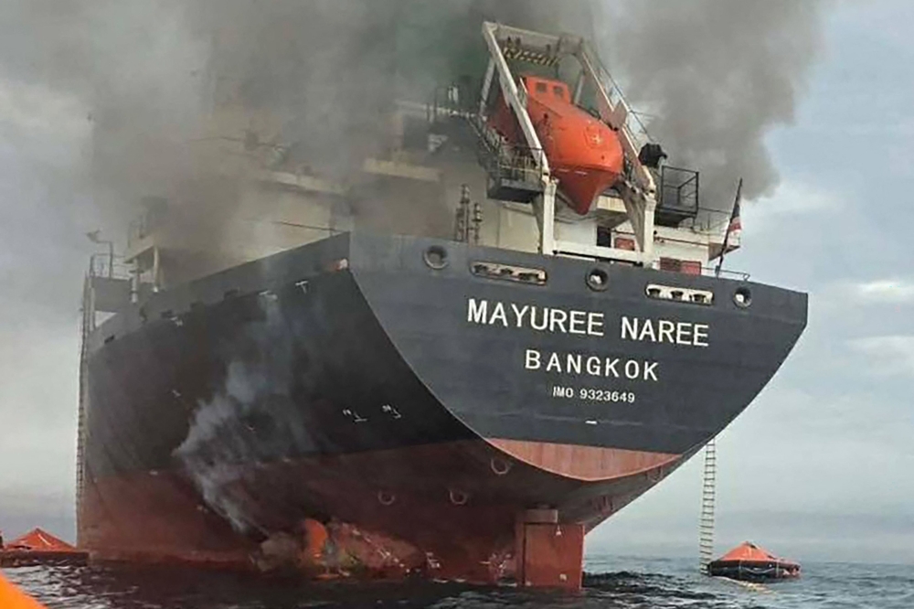 Smoke rises from the Thai bulk carrier 'Mayuree Naree' near the Strait of Hormuz after an attack on March 11, 2026. — AFP pic