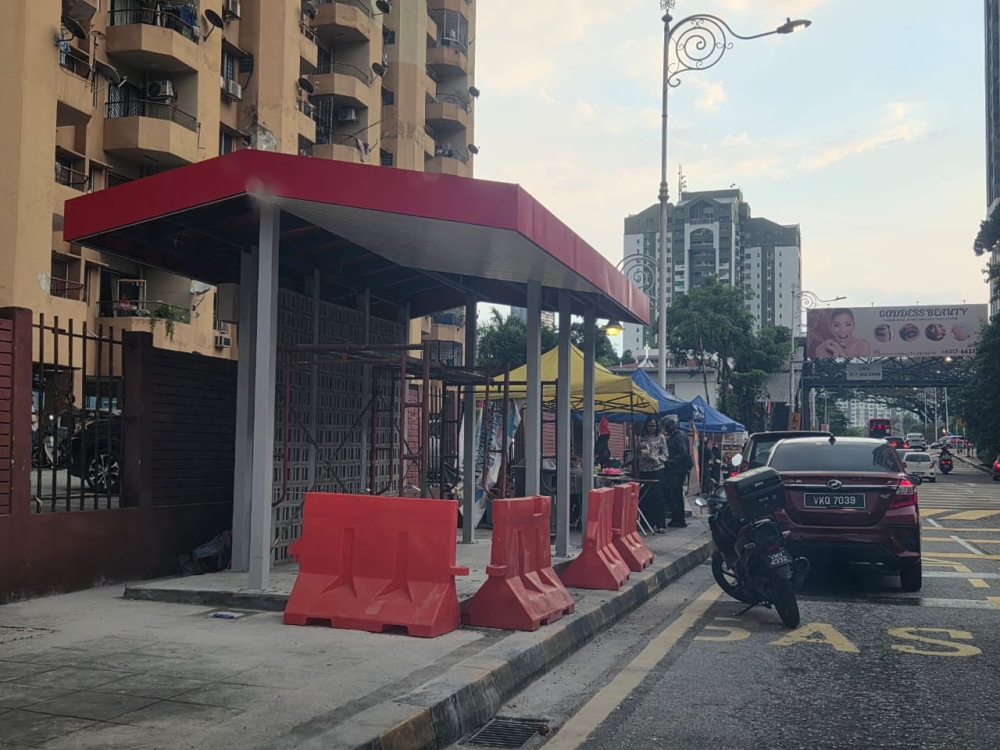 Bus stop under construction at Jalan Sultan Abdul Samad, replacing the previous lack of a proper waiting area.