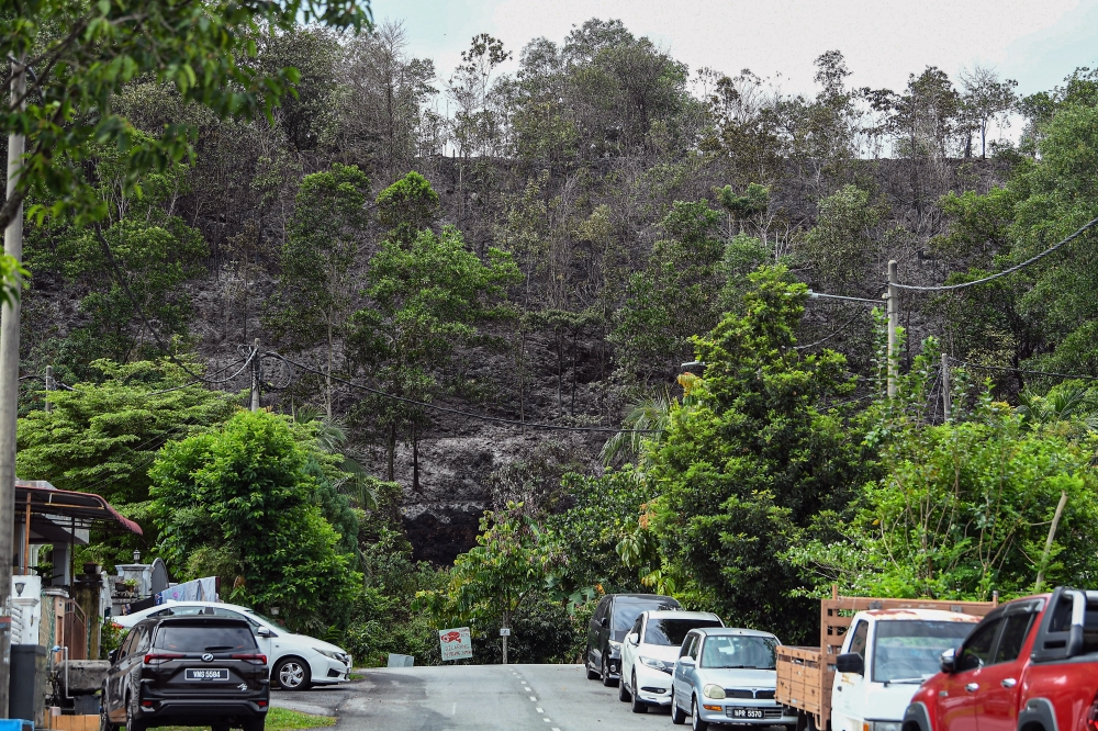 The hillside forest fire, covering an area of about 0.81 hectares near the Putrajaya Toll Plaza on the Kuala Lumpur-Putrajaya Expressway (MEX), was fully extinguished in the early hours today, March 12, 2026. — Bernama pic 